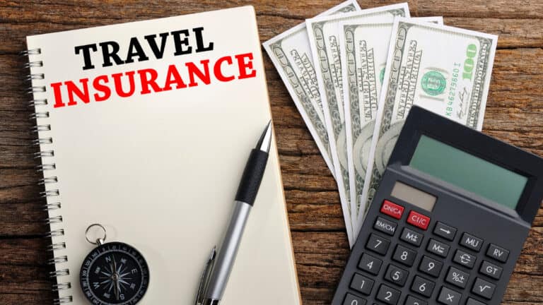 Travel Insurance Forms and Money on a desk