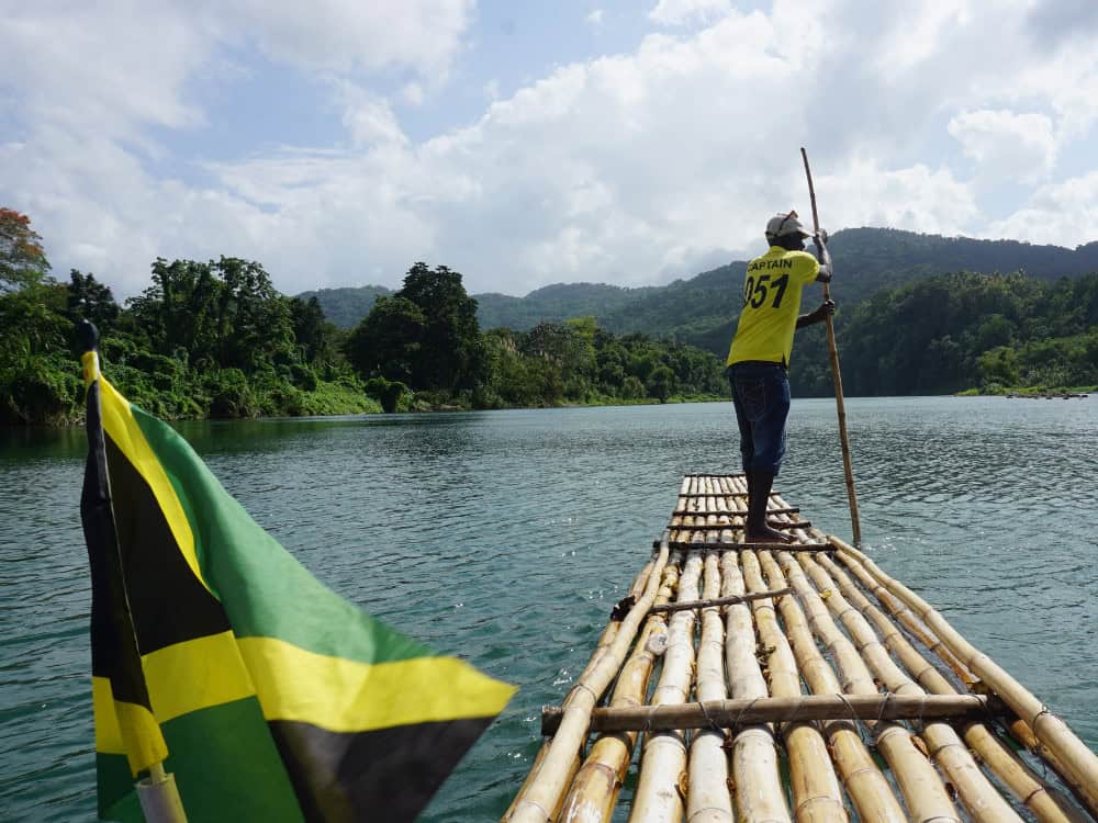 Man on Raft on Martha Brae river in Jamaica.